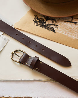 editorial image of The Foundation Belt in Dark Brown on sheets of paper, Accessories by Taylor Stitch