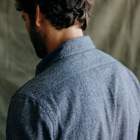 fit model showing the back of The Utility Shirt in Rinsed Indigo Herringbone