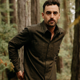 fit model wearing The Utility Shirt in Tarnished Brass Herringbone in the woods