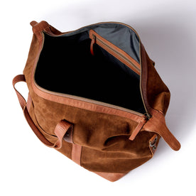 flatlay of The Weekender Duffle in Chocolate Roughout, shown open