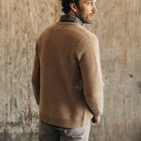 fit model showing the back of The Eddy Cardigan in Camel Herringbone Merino