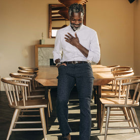 fit model leaning against a table in The Jack in Greystone University Stripe Oxford