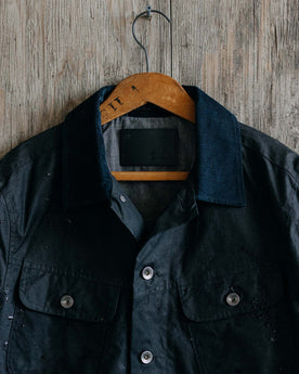 editorial image of The Long Haul Jacket in Coal Waxed Canvas hanging, Outerwear by Taylor Stitch