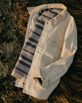 flatlay of The Workhorse Utility Jacket in Light Khaki Chipped Canvas on the grass, Outerwear by Taylor Stitch