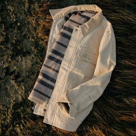 flatlay of The Workhorse Utility Jacket in Light Khaki Chipped Canvas on the grass