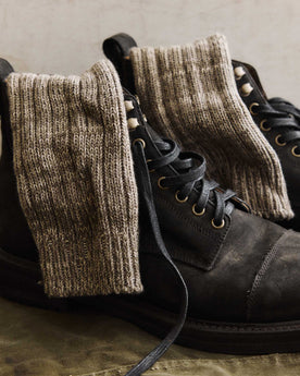 editorial image of The Camp Sock in Marled Smoked Olive in boots, Accessories by Taylor Stitch
