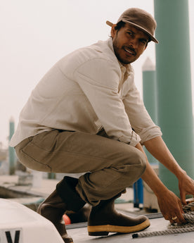 fit model leaning against the wall wearing The Chore Pant in Stone Chipped Canvas, Bottoms by Taylor Stitch