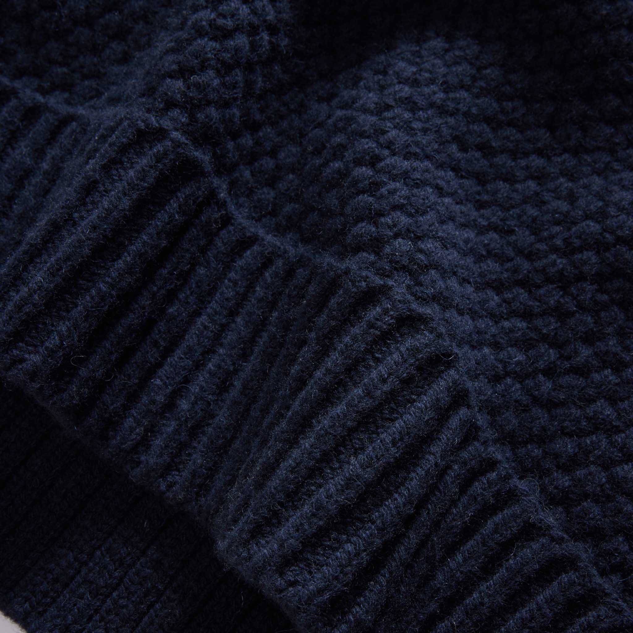 material shot of the hem on The Fisherman Sweater in Dark Navy Merino, Knits by Taylor Stitch
