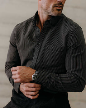 fit model adjusting the cuffs on The Jack in Roped Black Indigo, Wovens by Taylor Stitch