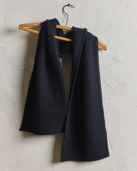 editorial image of The Textured Knit Scarf in Heather Navy Merino hanging, Accessories by Taylor Stitch