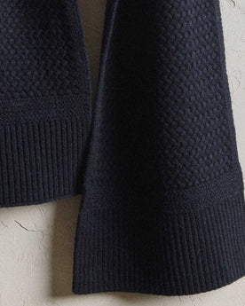 editorial image of the cuffs hanging on The Textured Knit Scarf in Heather Navy Merino, Accessories by Taylor Stitch