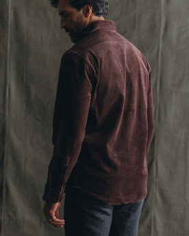fit model posing in The Utility Shirt in Burgundy Corduroy, Wovens by Taylor Stitch