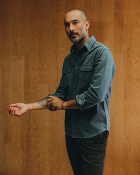 fit model standing wearing The Yosemite Shirt in Slate, Wovens by Taylor Stitch