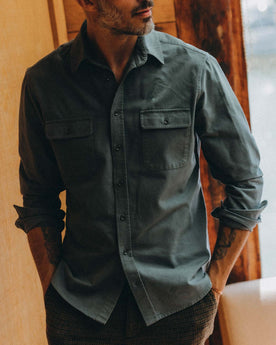 fit model standing next to fishing rope wearing The Yosemite Shirt in Slate, Wovens by Taylor Stitch
