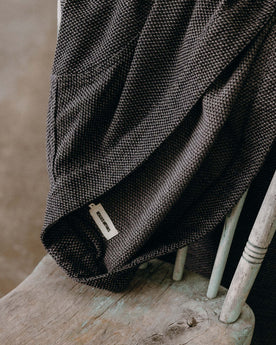 The Apres Robe in Charcoal Sashiko folded on a chair, Accessories by Taylor Stitch