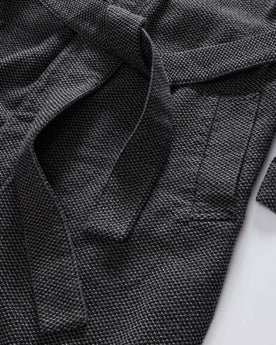 editorial flatlay of the pocket on The Apres Robe in Charcoal Sashiko, Accessories by Taylor Stitch