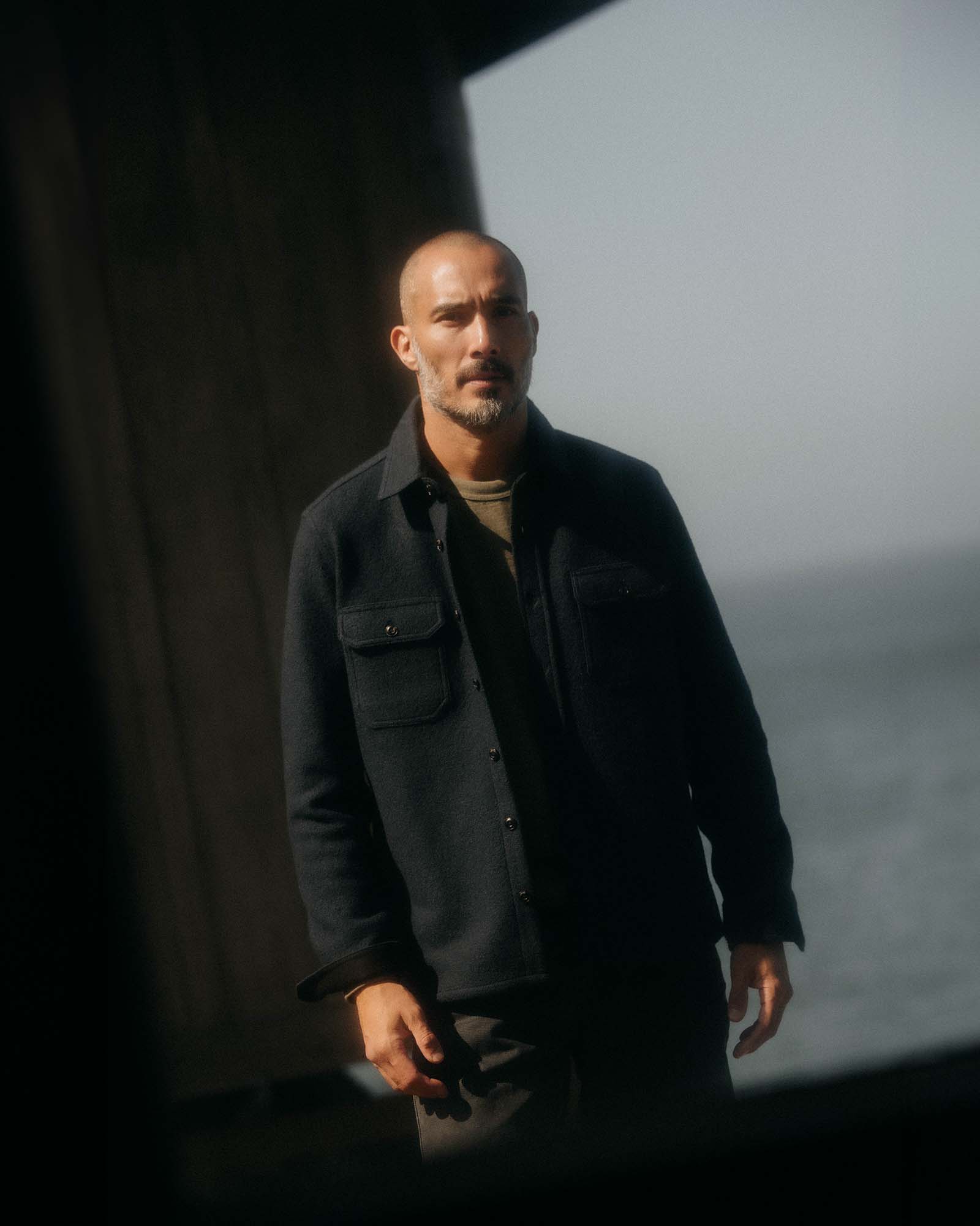 fit model adjusting the cuffs wearing The Connor Overshirt in Dark Navy Boucle, Wovens by Taylor Stitch