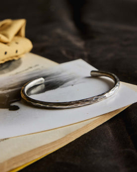 editorial image of The Hammered Cuff in Sterling Silver on a piece of paper, Accessories by Taylor Stitch