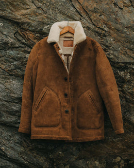 editorial image of The High Plains Coat in Walnut Shearling hanging, Outerwear by Taylor Stitch