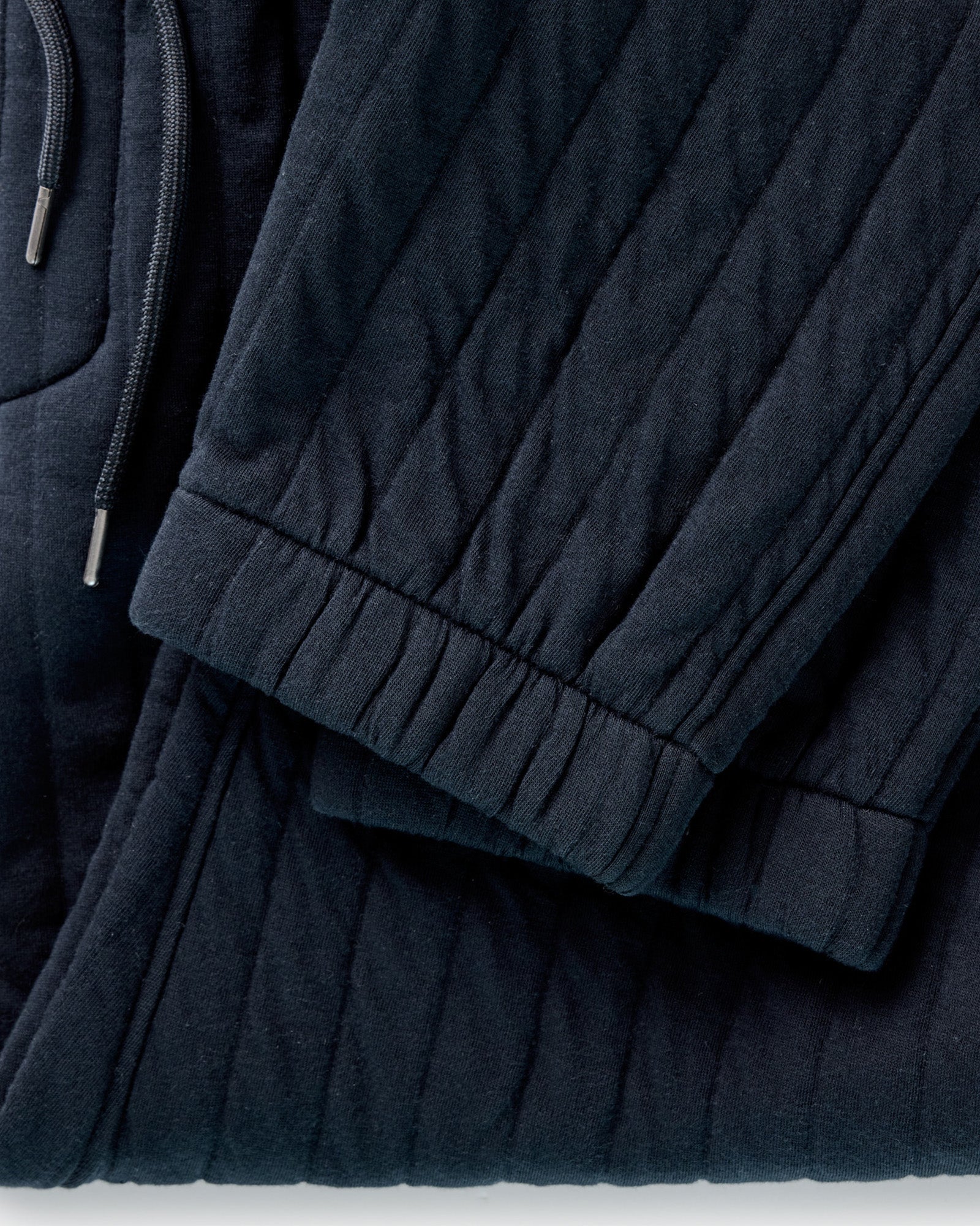material shot of the pocket on The Quilted Apres Pant in Heather Midnight Jersey, Bottoms by Taylor Stitch