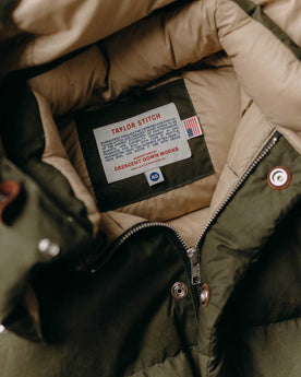 material shot of the collar on The Down Sweater in Olive Waxed Ripstop, Outerwear by Taylor Stitch