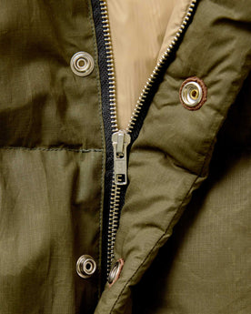 material shot of the zipper on The Down Sweater in Olive Waxed Ripstop, Outerwear by Taylor Stitch