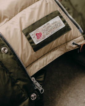 material shot of the lining on The Down Sweater in Olive Waxed Ripstop, Outerwear by Taylor Stitch