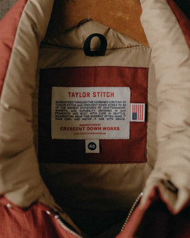 material shot of the tag on The Down Vest in Brick Red Waxed Ripstop, Outerwear by Taylor Stitch