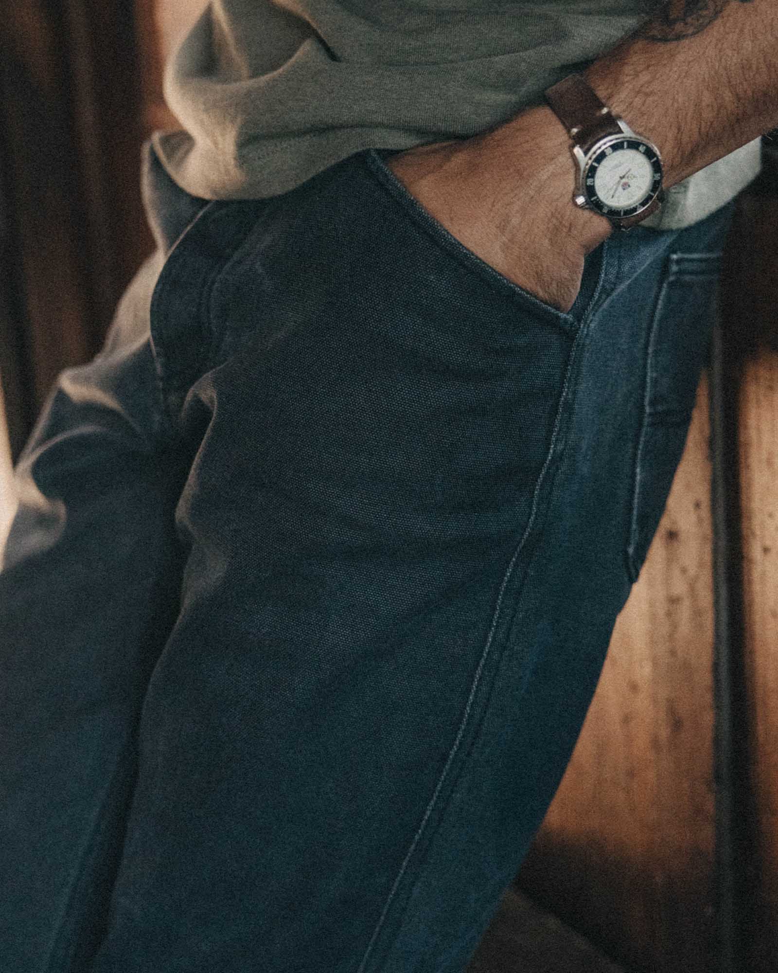fit model with his hand in his pocket wearing The Camp Pant in Coal Chipped Canvas, Bottoms by Taylor Stitch