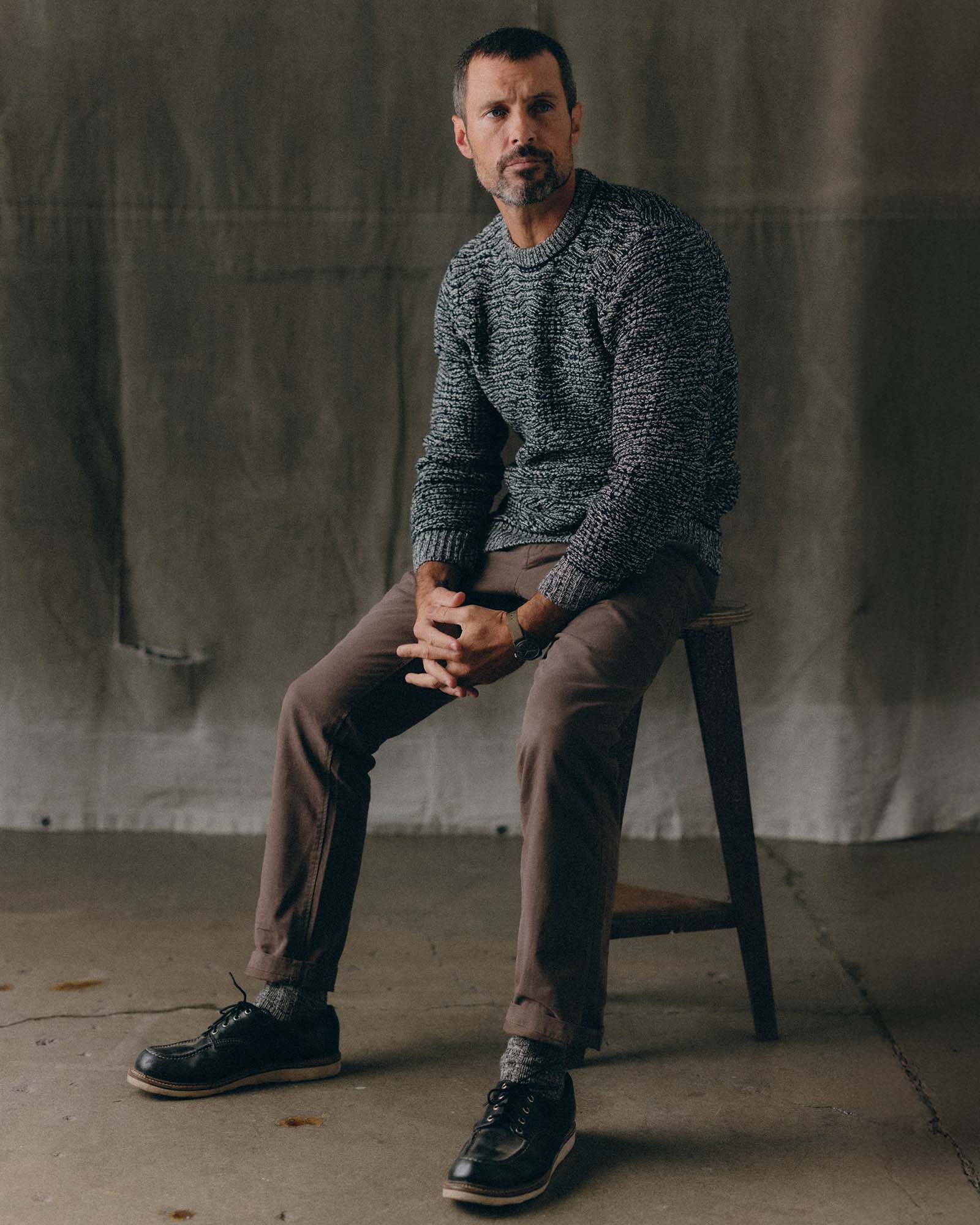 fit model sitting wearing The Chatham Crew in Marine Stripe Jacquard, Knits by Taylor Stitch