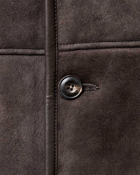 material shot of the button on The Coleman Jacket in Dark Chocolate Shearling Suede, Outerwear by Taylor Stitch
