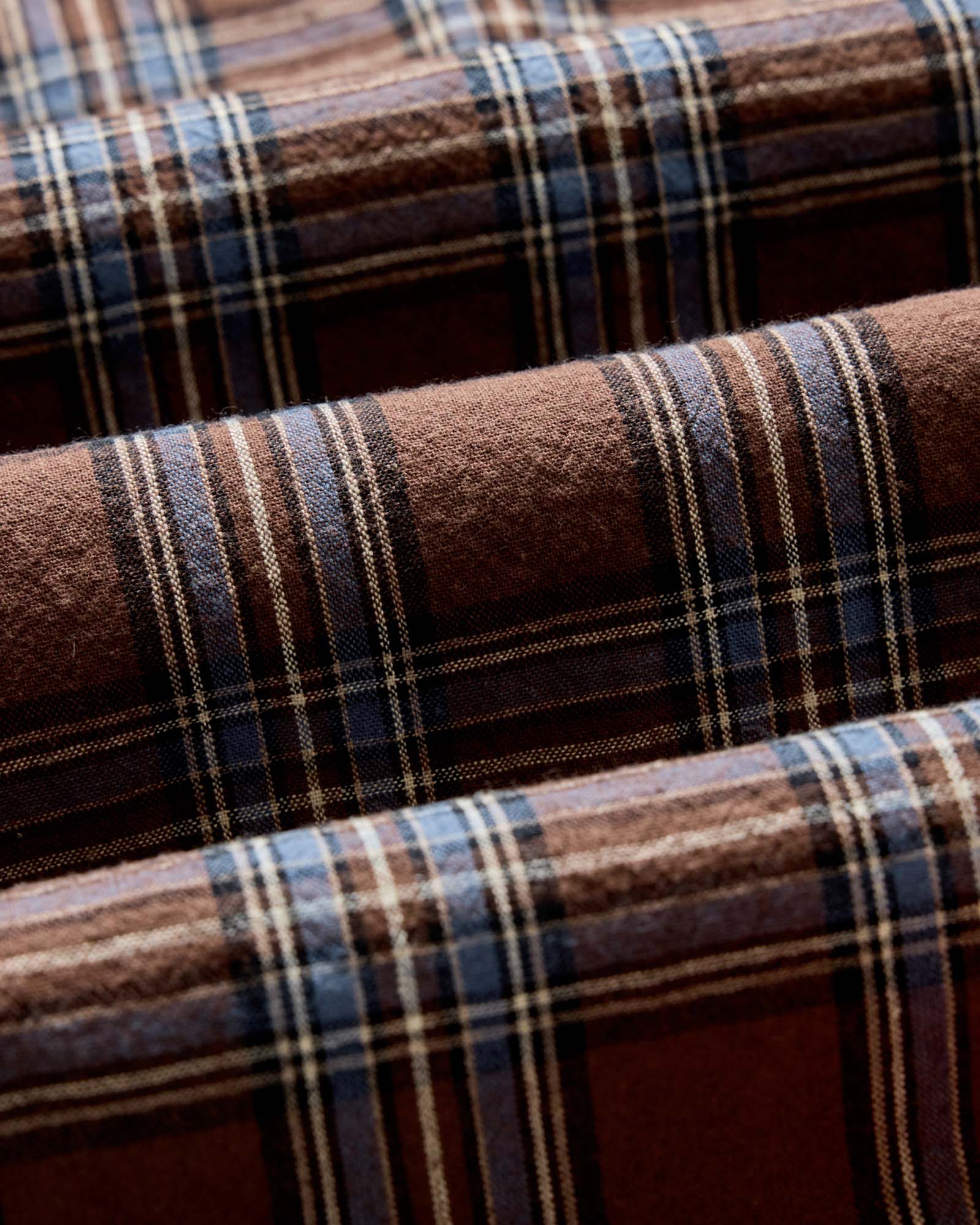 material shot of the fabric on The Craftsman Shirt in Brick Plaid, Wovens by Taylor Stitch