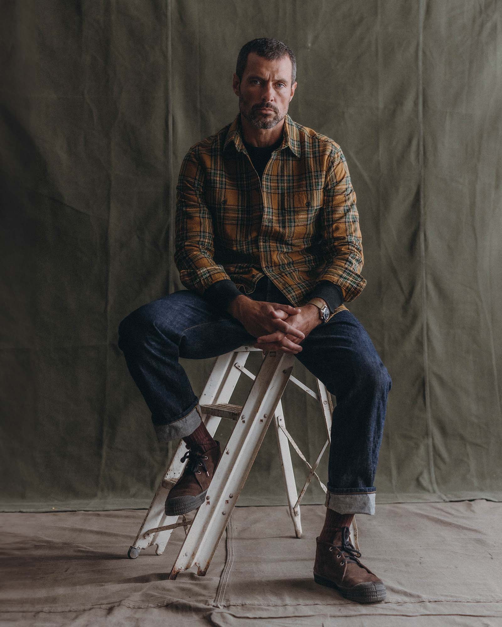 fit model sitting wearing The Craftsman Shirt in Fern Plaid, Wovens by Taylor Stitch