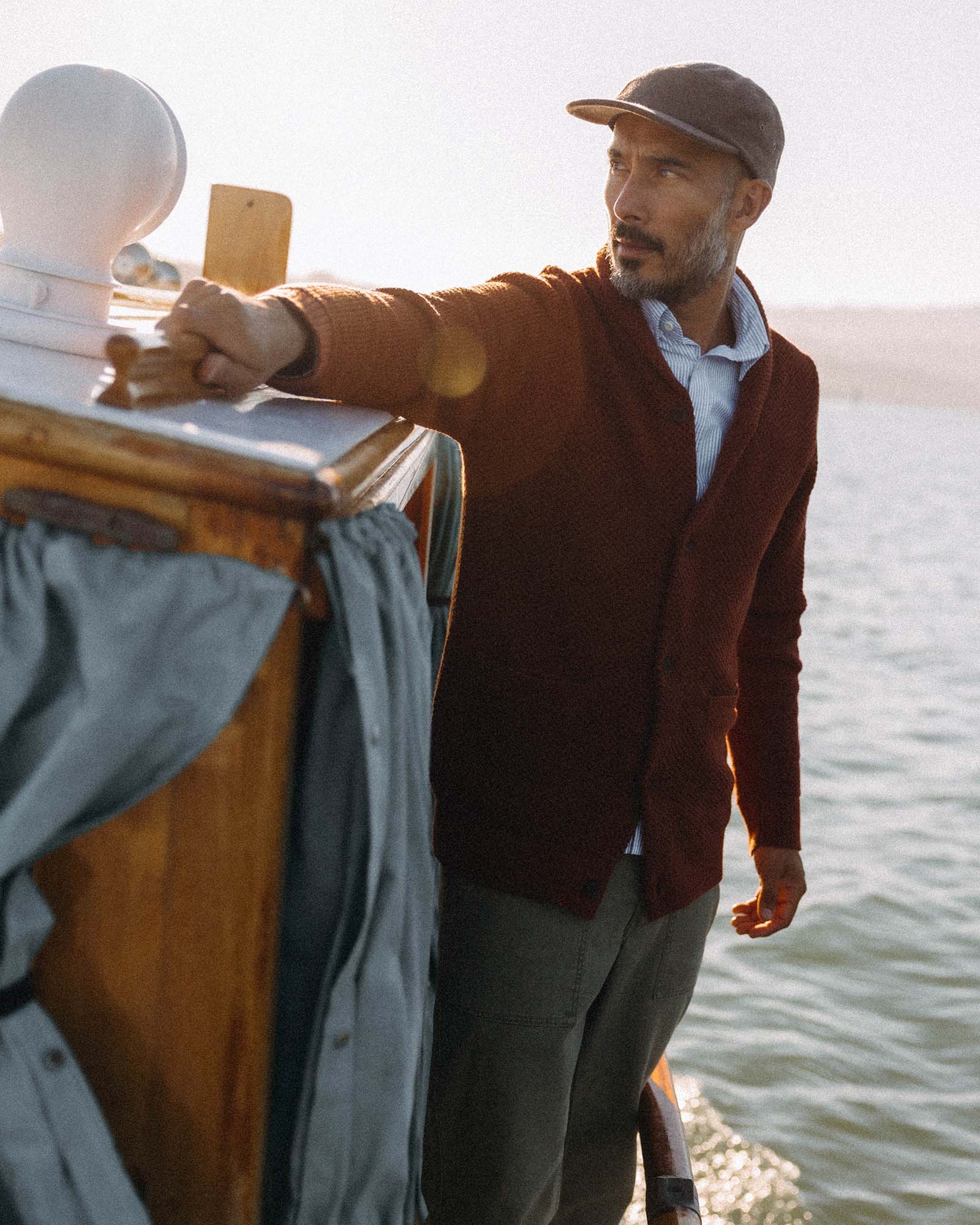 fit model posing in The Crawford Sweater in Rust, Knits by Taylor Stitch