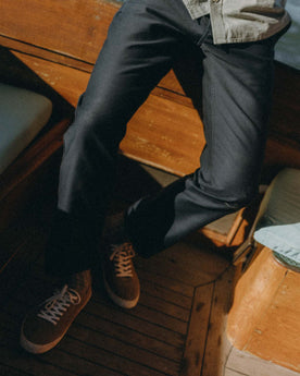 fit model sitting wearing The Deck Pant in Dark Navy Bedford Cord, Bottoms by Taylor Stitch