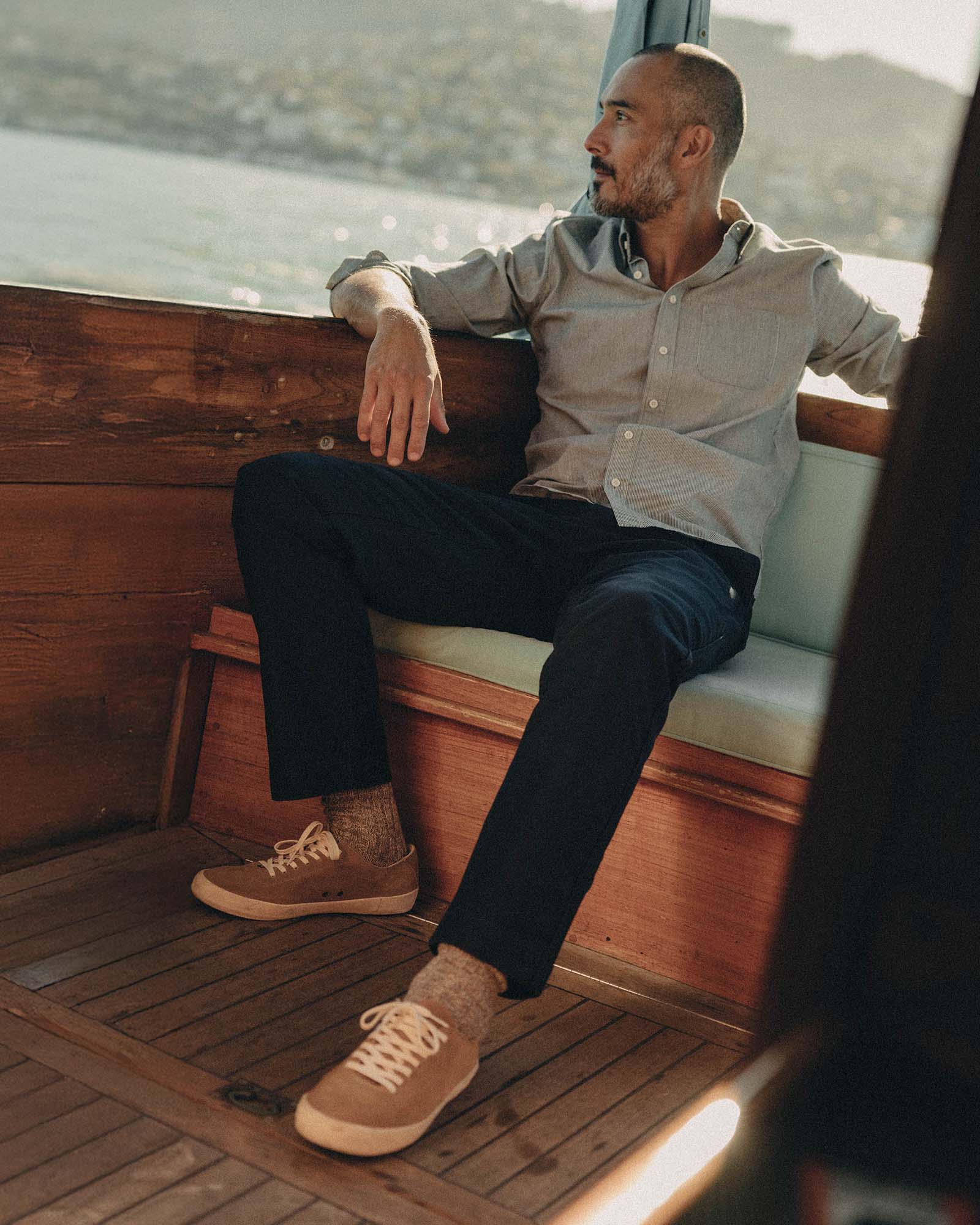 fit model sitting wearing The Deck Pant in Dark Navy Bedford Cord, Bottoms by Taylor Stitch
