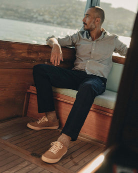 fit model sitting wearing The Deck Pant in Dark Navy Bedford Cord, Bottoms by Taylor Stitch