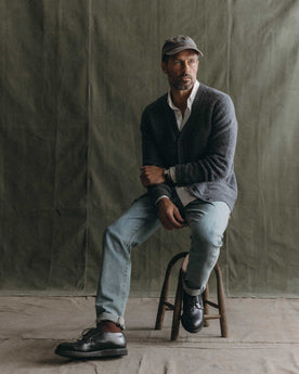 fit model sitting wearing The Eastmoor Cardigan in Heather Graphite Wool, Knits by Taylor Stitch