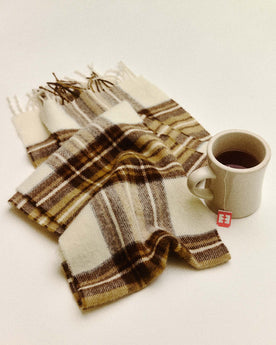 editorial flatlay of The Fireside Scarf in Butterscotch Plaid next to a cup of tea, Accessories by Taylor Stitch