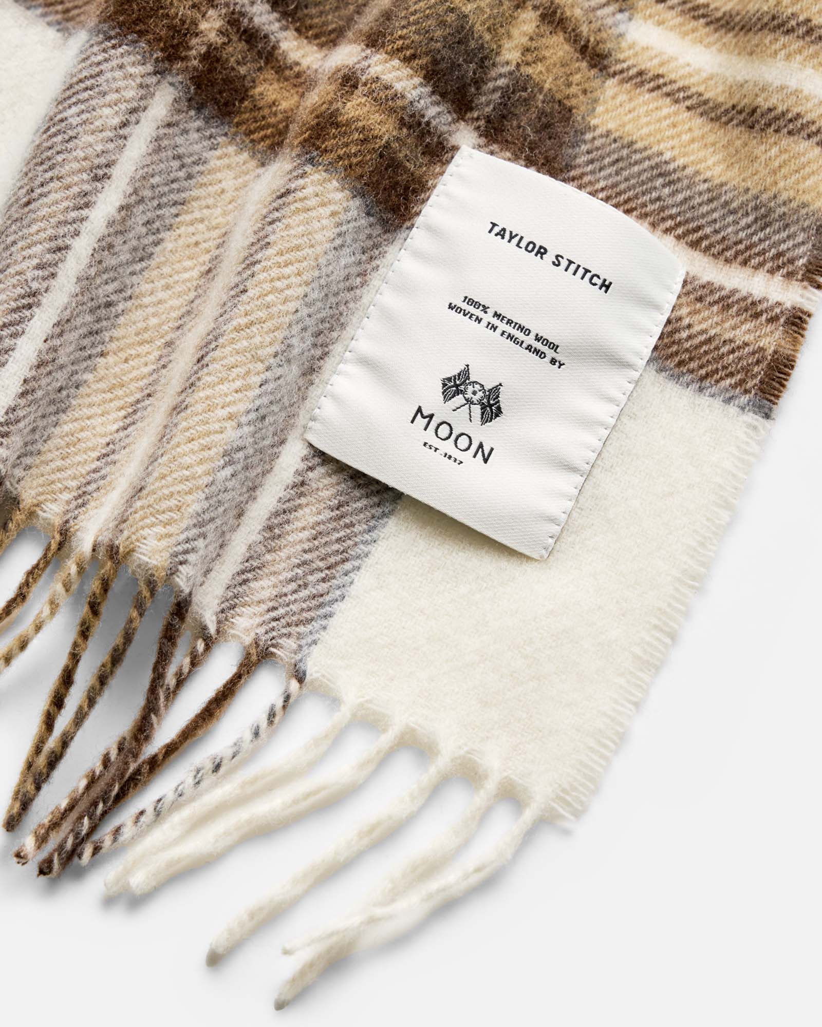 material shot of the label on The Fireside Scarf in Butterscotch Plaid, Accessories by Taylor Stitch