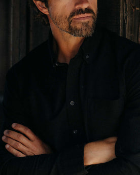 fit model showing off the buttons on The Jack in Black Indigo Oxford, Wovens by Taylor Stitch