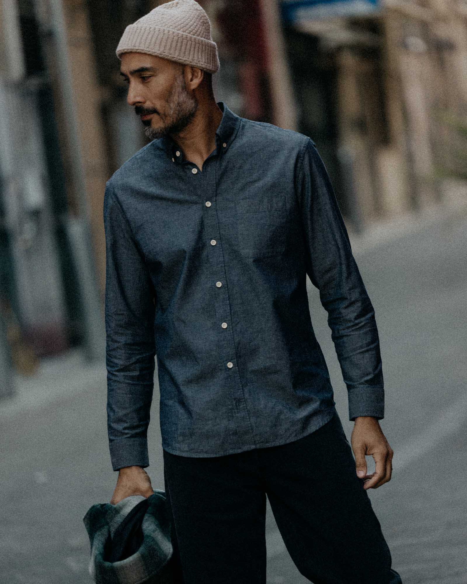 fit model looking out the window wearing The Jack in Rinsed Indigo Chambray, Wovens by Taylor Stitch