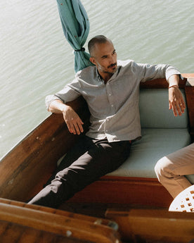 fit model sitting wearing The Jack in Rinsed Indigo Stripe Chambray, Wovens by Taylor Stitch