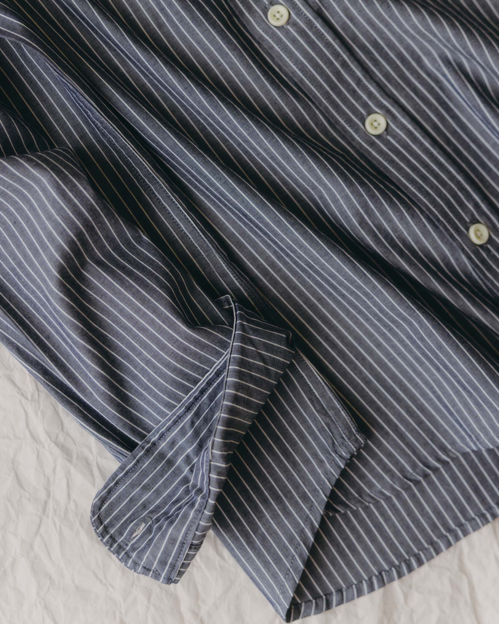 fit model showing off the pocket on The Jack in Rinsed Indigo Stripe, Wovens by Taylor Stitch