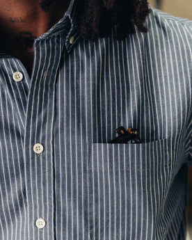 fit model showing off the pocket on The Jack in Rinsed Indigo Stripe, Wovens by Taylor Stitch