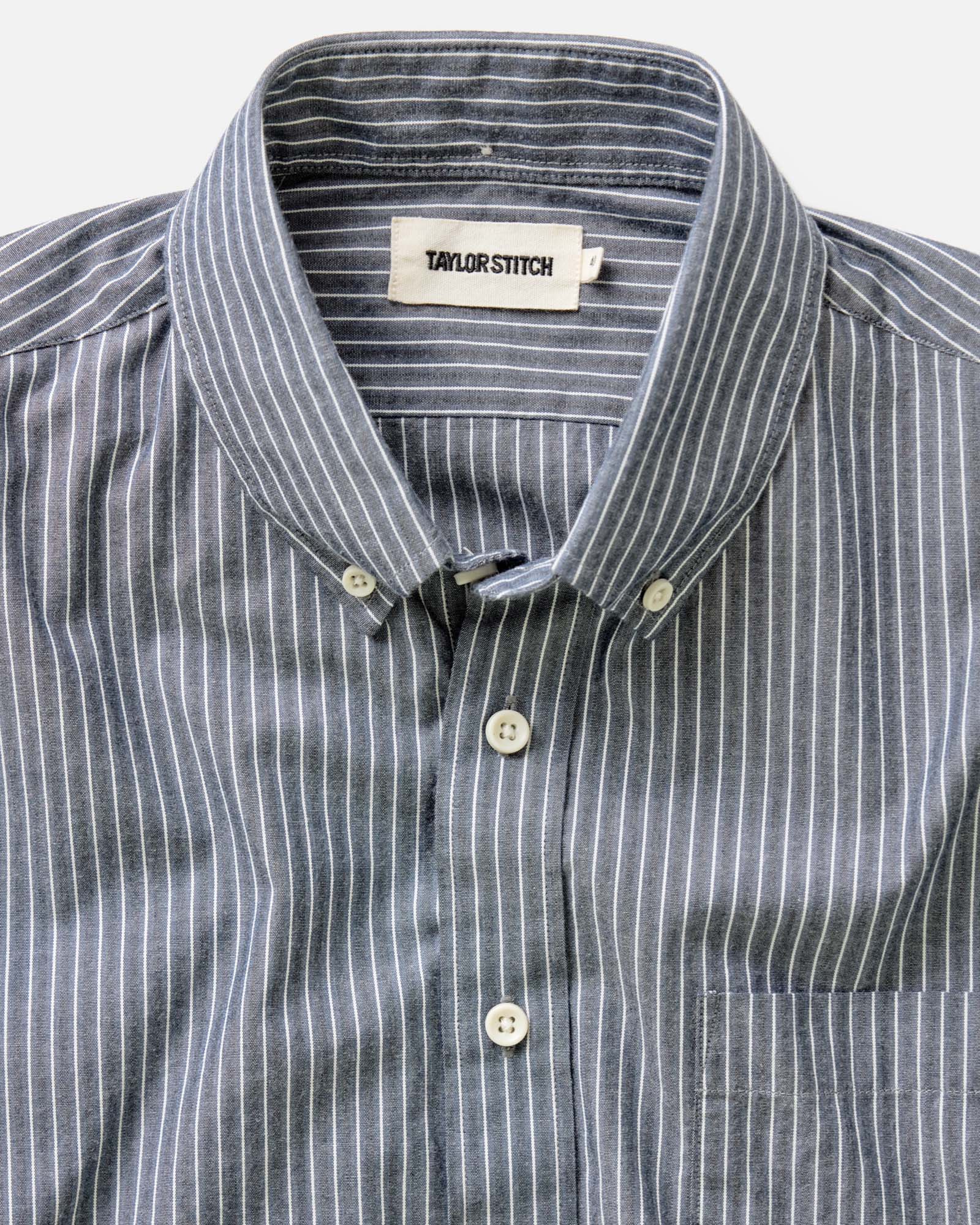 fit model sitting wearing The Jack in Rinsed Indigo Stripe, Wovens by Taylor Stitch