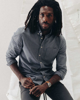 fit model sitting wearing The Jack in Rinsed Indigo Stripe, Wovens by Taylor Stitch