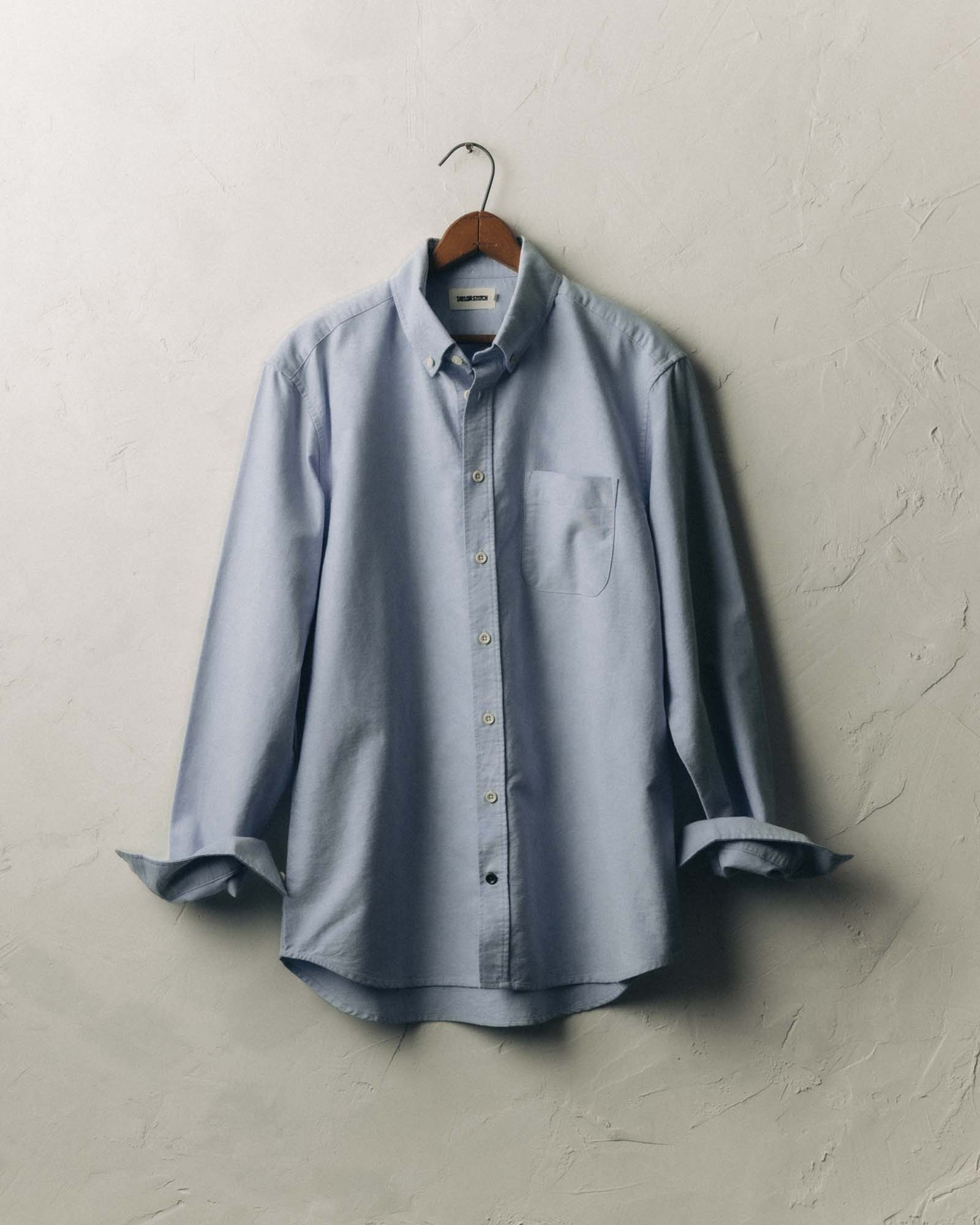 fit model with his hand in his pocket wearing The Jack in Blue Everyday Oxford, Wovens by Taylor Stitch