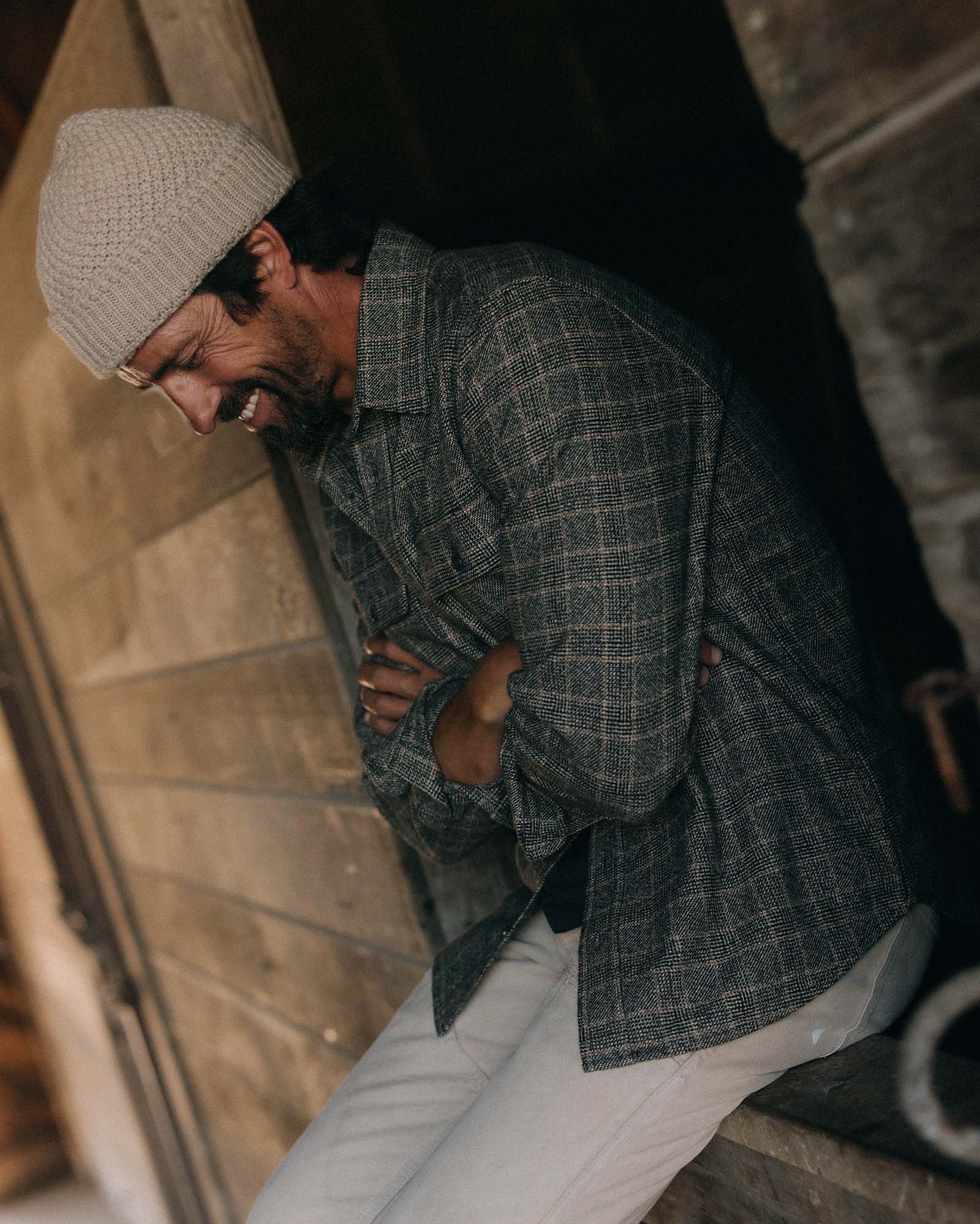 fit model sitting wearing The Ledge Shirt in Coal Plaid, Wovens by Taylor Stitch