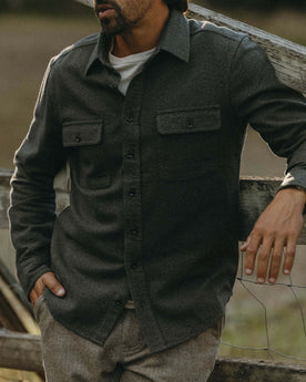 fit model leaning against the fence wearing The Ledge Shirt in Pine Twist, Wovens by Taylor Stitch